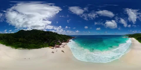 Beach with turquoise waves and lush hills. La Digue, Seychelles. Stock Footage 323151067