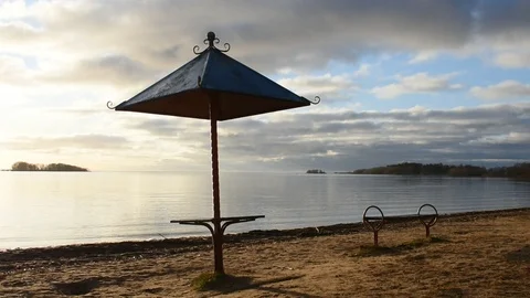 Beach umbrella and bench on an empty beach Stock Footage 122734804