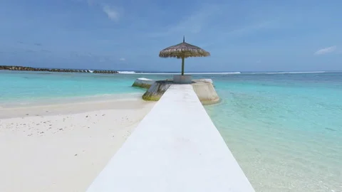 Beach umbrella on beach, Sangeli Island, Kaafu Atoll, Maldives Stock Footage