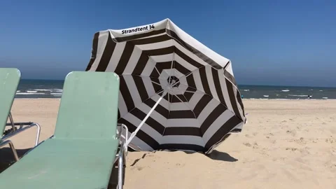 Beach umbrella blowing in the wind Video stock 154952175