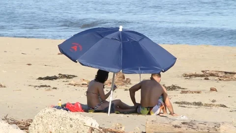 Beach umbrella couple Stock Footage 4497747