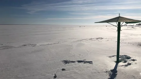 Beach with umbrella during winter Stock Footage 142456101