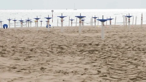 Beach Umbrella lines On A Empty Beach In Winter Stock Footage 117410191