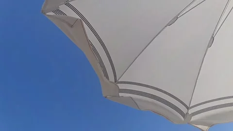Beach umbrella moved by the summer wind - Slow motion HD Stock Footage 313982912