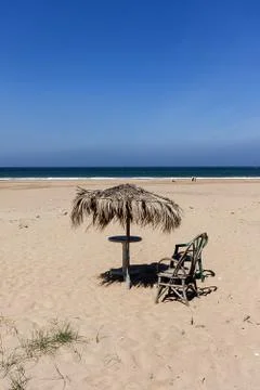 Beach with umbrella Stock Photos
