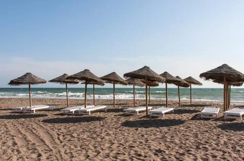 Beach with umbrella Stock Photos