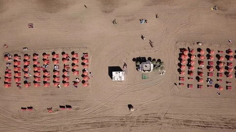 Beach umbrellas and ocean waves top down view from above, Canary islands Stock Footage 105681649