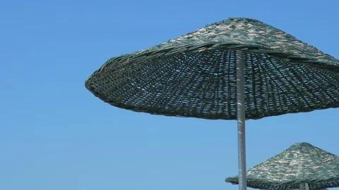 Beach umbrellas on a background of blue sky. Stock-Footage 119579463