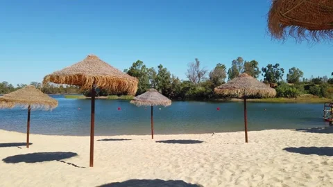 Beach umbrellas on a background of blue sky. Video stock 134977487