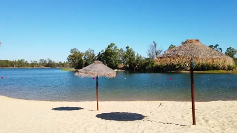 Beach umbrellas on a background of blue sky. Video stock 134977518
