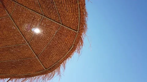 Beach umbrellas on a background of blue sky. Video stock 134977617
