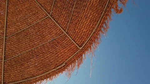 Beach umbrellas on a background of blue sky. Video stock 134977675