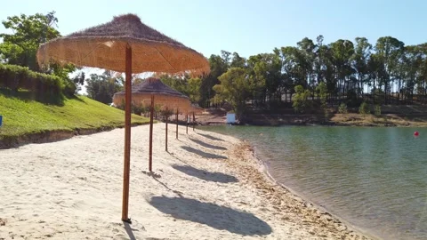 Beach umbrellas on a background of blue sky. Video stock 134977722