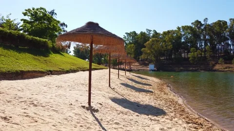 Beach umbrellas on a background of blue sky. Video stock 134977724