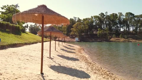 Beach umbrellas on a background of blue sky. Video stock 134977736