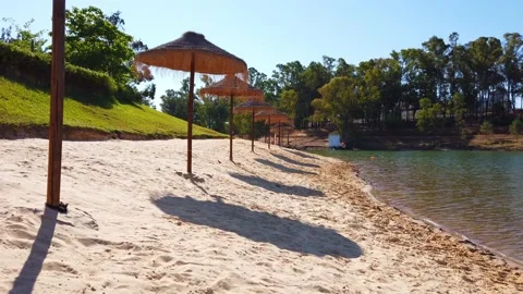 Beach umbrellas on a background of blue sky. Video stock 134977740
