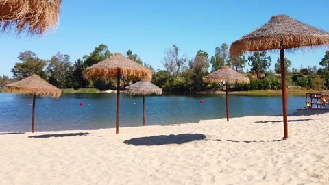 Beach umbrellas on a background of blue sky. Video stock 134977749