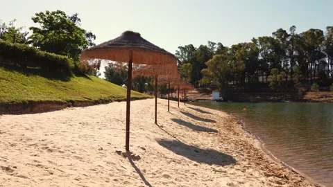 Beach umbrellas on a background of blue sky. Video stock 134977760