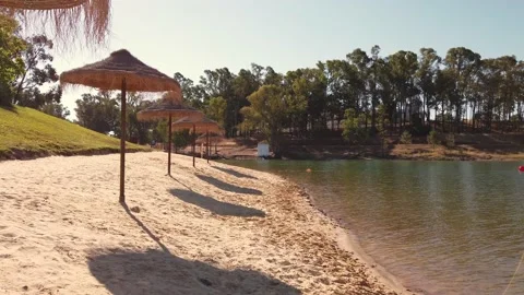 Beach umbrellas on a background of blue sky. Video stock 134977798