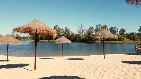 Beach umbrellas on a background of blue sky. Video stock 134977854