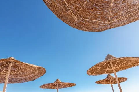 Beach umbrellas on a background of blue sky Stock Photos