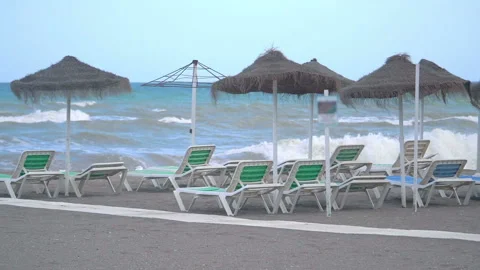 Beach umbrellas  on the empty closed beach during pandemic time in slow motion 動画素材 145935688