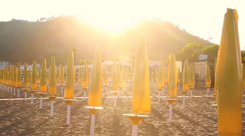 Beach umbrellas at sunset Video stock 51628551