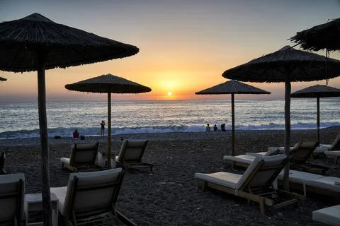 Beach Umbrellas with sunset Stock Photos