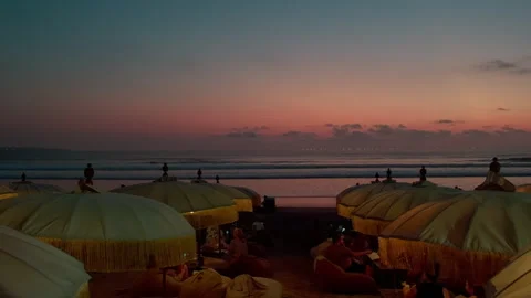 Beach umbrellas at sunset , Seminyak Beach, Bali 库存影片 336514911