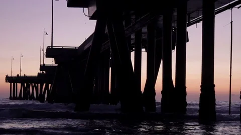 Beach Underneath Pier at Dusk Stock Footage 99597291