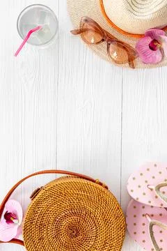 Beach vacation background - flatlay with straw hat and rattan bag Stock Photos