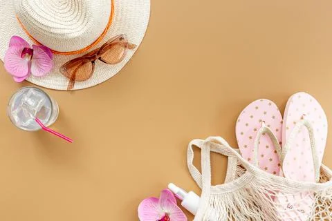 Beach vacation background - flatlay with straw hat and rattan bag Stock Photos