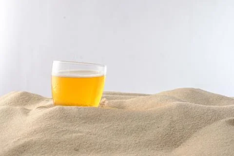 Beach vacation concept. Cool drinks on the beach sand. Cold foamy beer. Close Stock Photos