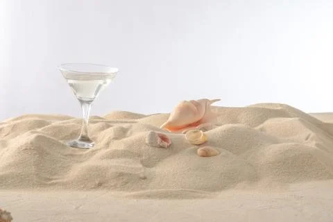 Beach vacation concept. Cool drinks on the beach sand. A glass of refreshing  Stock Photos