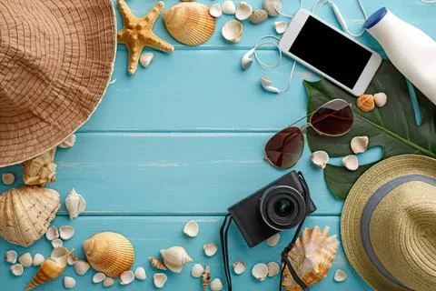 Beach vacation flat lay with hat camera phone sunglasses Stock Photos