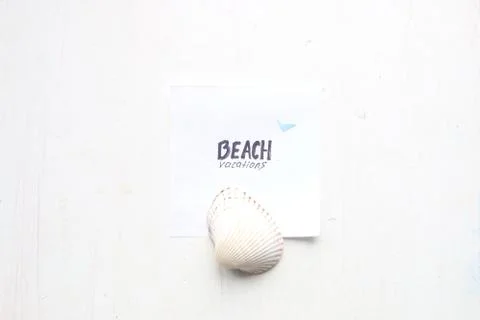 Beach vacation text and seashell Stock Photos