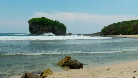 Beach view calm waves white sand blue water sky big rock sea shore coast line Stock-Footage 267345722