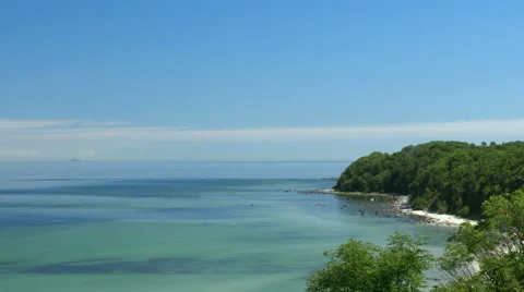 Beach view from cliff. Bay with blue sky. Rügen - Baltic Sea. 스톡 동영상 65723167