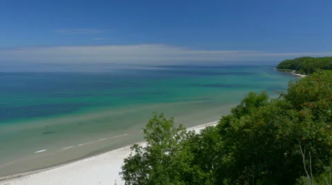 Beach view from cliff. Bay with blue sky. Rügen - Baltic Sea. Video stock 65725691