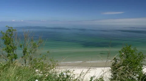 Beach view from cliff. Blue sky. Rügen - Baltic Sea. 스톡 동영상 65724007