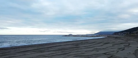Beach view from drone on cloudy afternoon in cinemascope Stock Footage 307147207