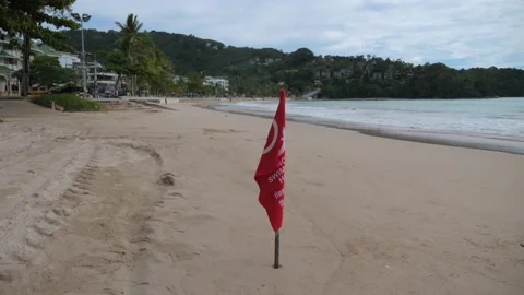Beach view with red flag indicating text no swimming zone Stock Footage 275611864