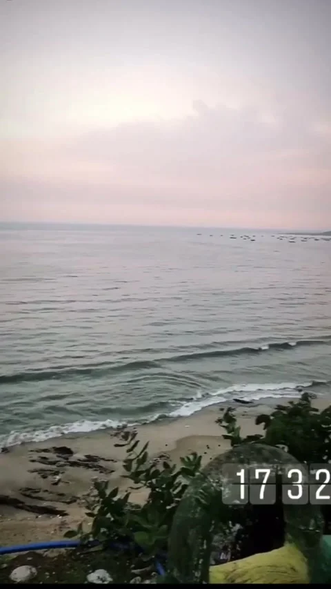 Beach view from top sunset orange sky people walking natural sounds Stock Footage 137087859