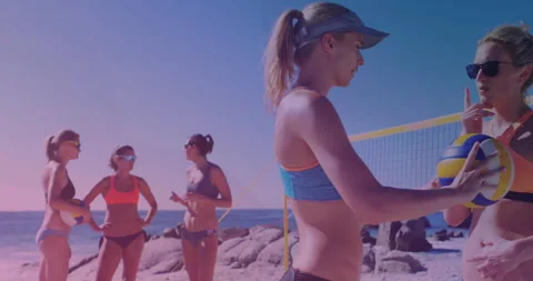 Beach volleyball player in blue receiving ball near net and listening to signal Stock Footage 311084764