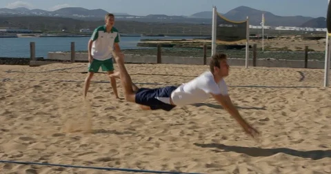 A Beach Volleyball Player dives to hit ball. Video stock 71985488