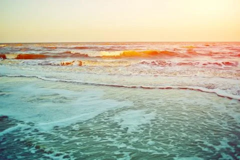 Beach with wave and pebbles Stock Photos