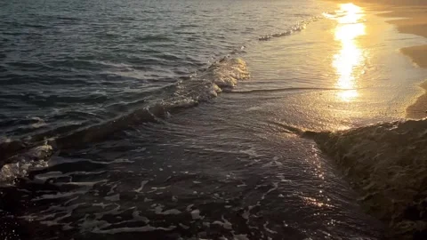 Beach with wave and sands on sunset with sun light path diagonally composition Stock Footage 259697136