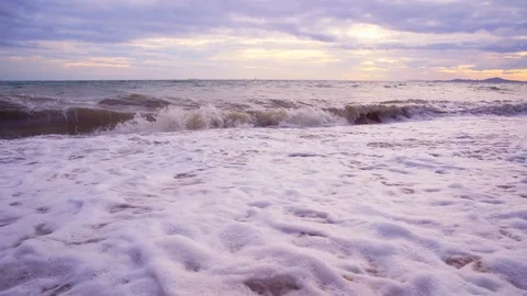 Beach wave rolling toward camera in low angle view footage Stock Footage 93639750