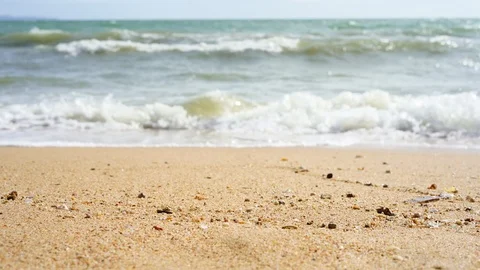 Beach wave rolling toward camera in low angle view footage Video stock 93643243