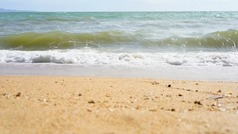 Beach wave rolling toward camera in low angle view footage Video stock 93643281